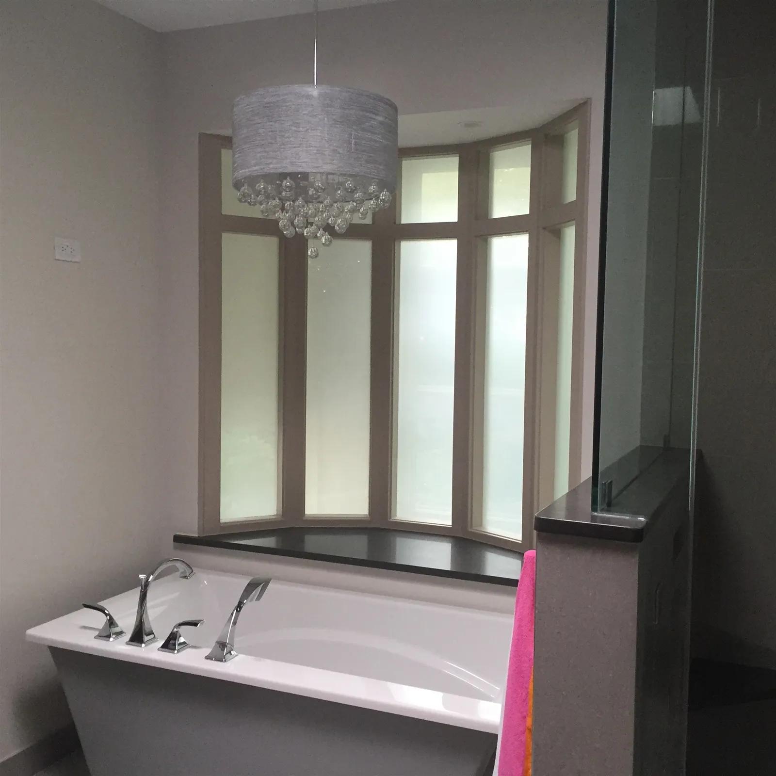 Bathroom with freestanding soaking tub under a window