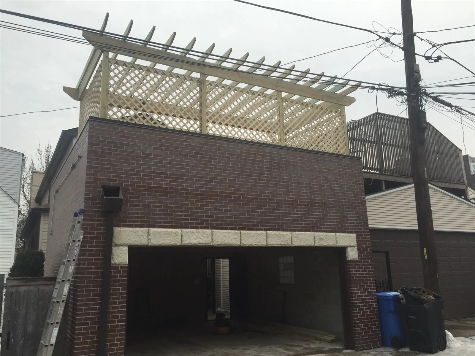 Deck with a pergola built on top of a garage