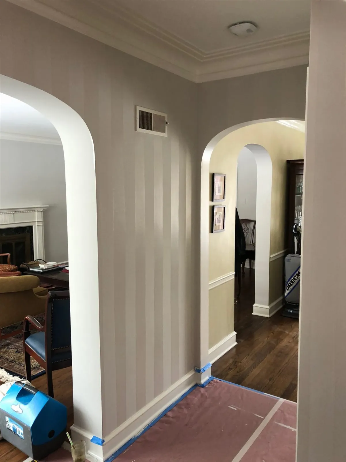Hallway with arched openings and a wood floor during work