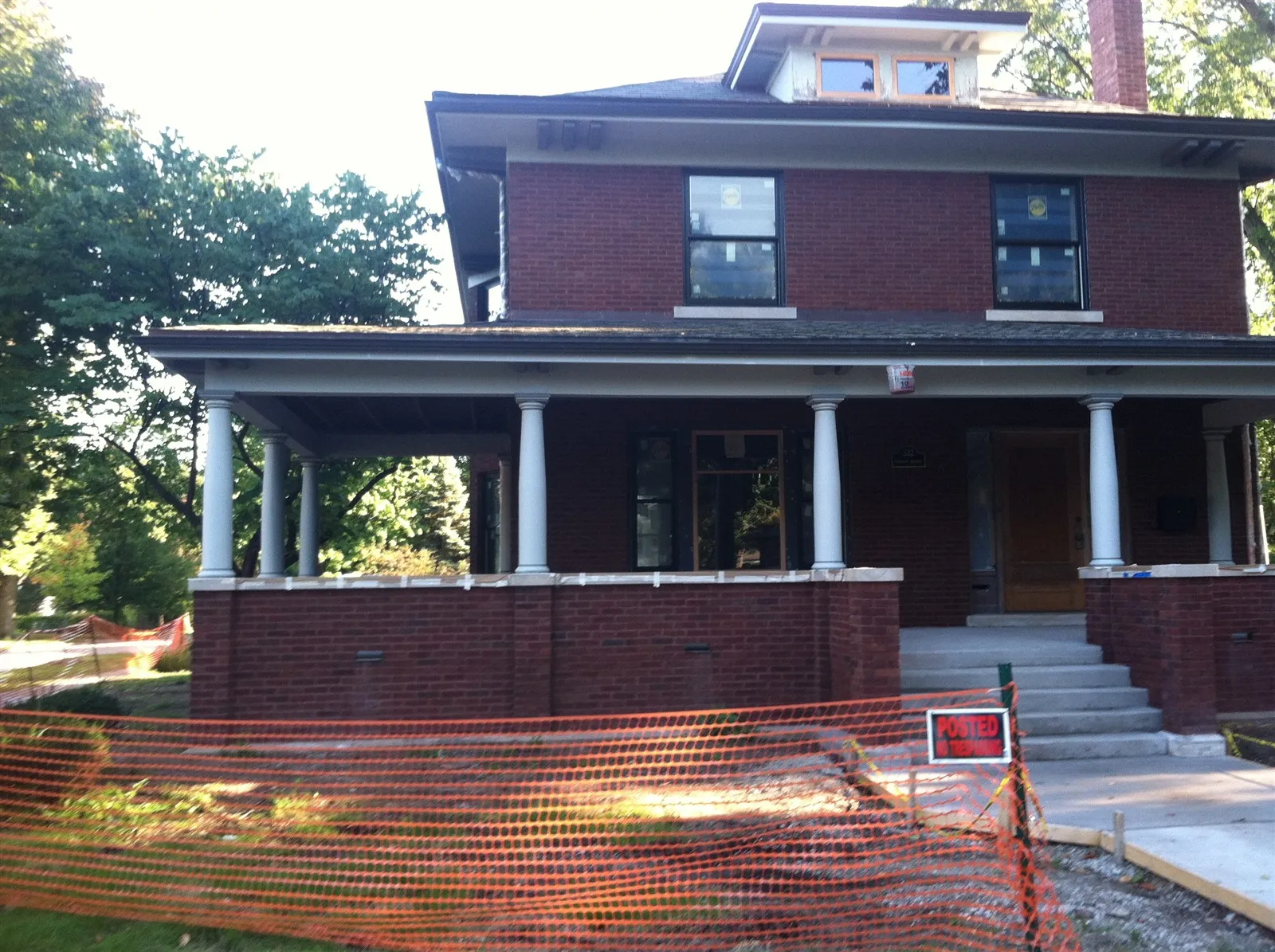 Large front porch under construction on a brick foursquare house